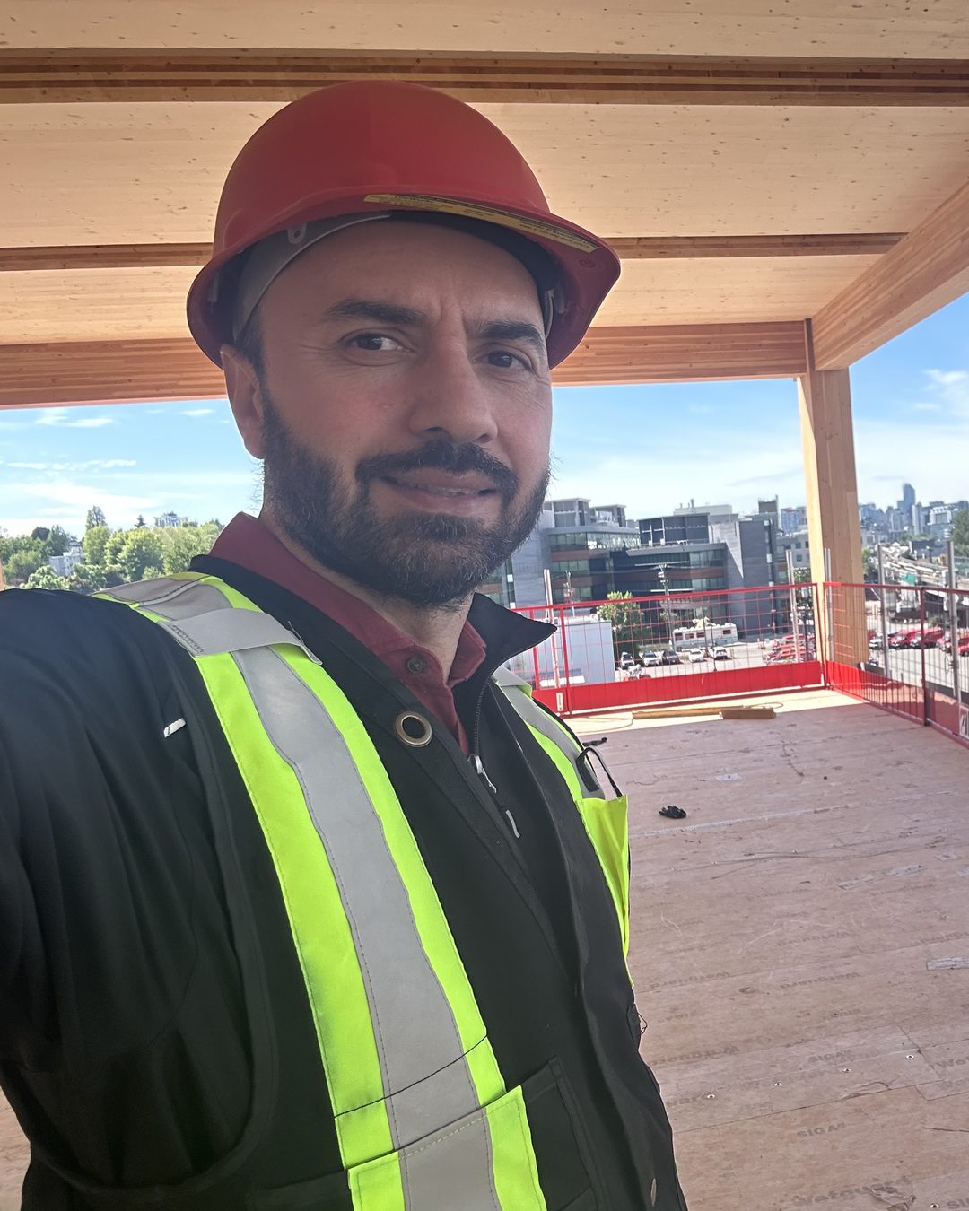 Ben, founder of Metrotech, in a hard hat and safety vest on a mass-timber construction site