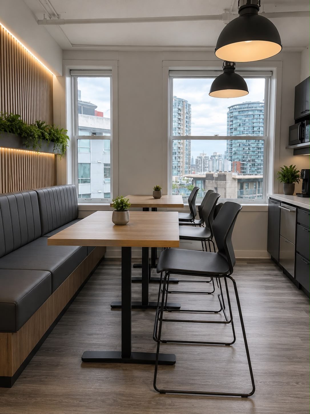 Staff lounge with banquette seating, tables and a servery